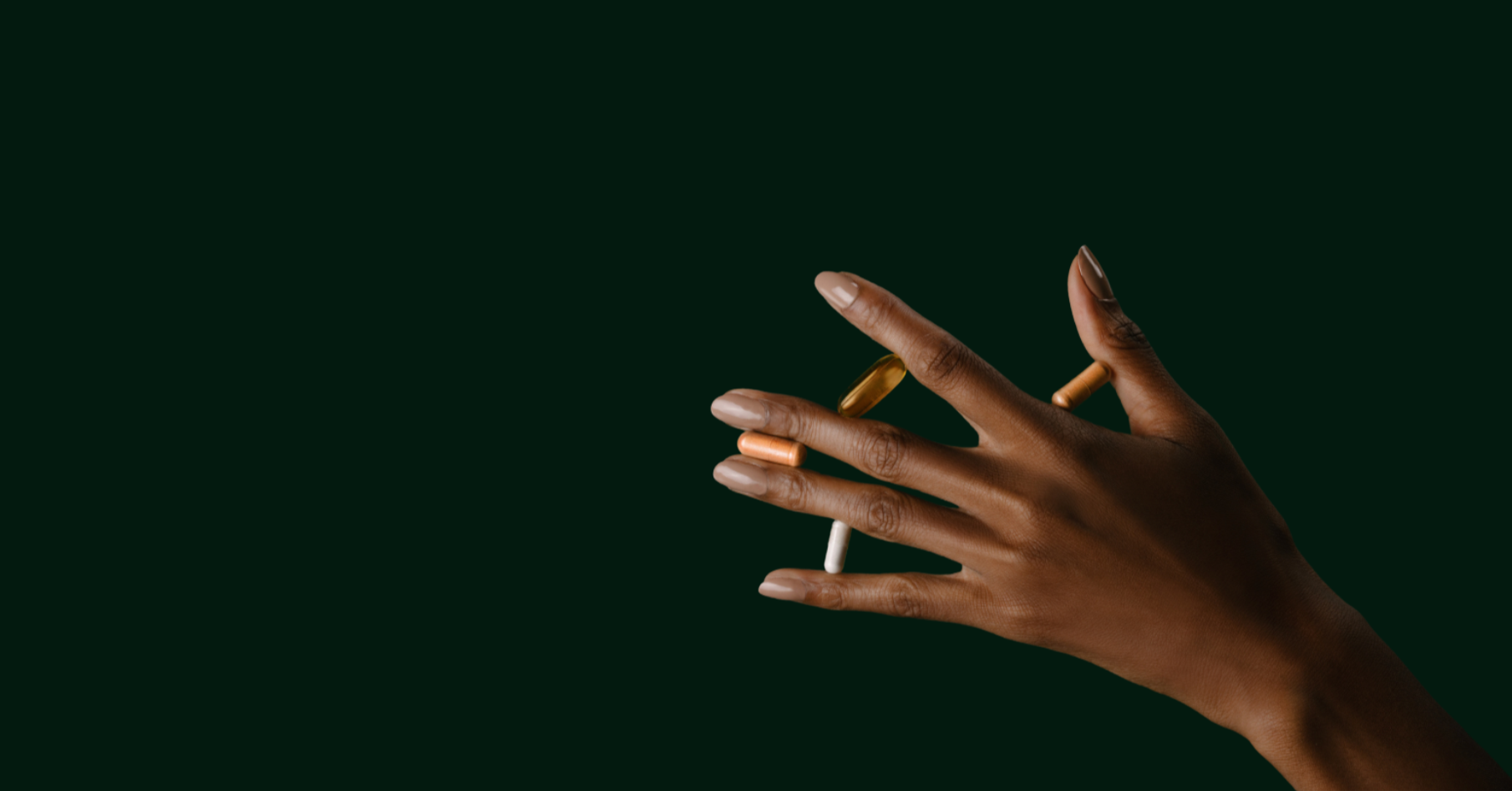Hand holding a lit match against a black background